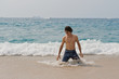 Athletic and muscular man in the surf of the Pacific Ocean.