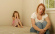 Photo: Mom and daughter sitting on an old mattress looking concerned Mom and daughter sitting on an old mattress looking concerned