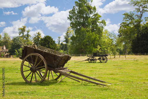 Photo: Old wooden wagons in the meadows of the farm of Versailles Old wooden wagons in the meadows of the farm of Versailles