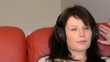Relaxed woman listening music sitting on sofa at home Relaxed woman listening music sitting on sofa at home