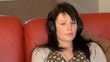 Relaxed woman sitting on sofa and listening music at home Relaxed woman sitting on sofa and listening music at home