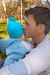 The father in park on a grass sad kisses the son The father in park on a grass sad kisses the son