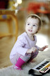 Little girl playing toy piano