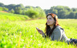 girl listening to music in ear-phones in park