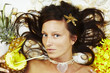 Beautiful exotic girl with Hawaiian accessories lying