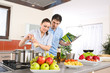 Young happy couple cook in kitchen with cookbook Young happy couple cook in kitchen with cookbook