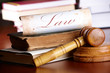 Judges gavel with very old books