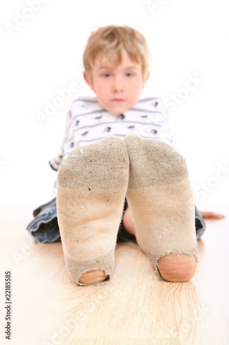 Photo: Boy wearing dirty socks with holes in them Boy wearing dirty socks with holes in them