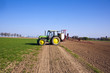 tractor on field sputtering pest protection