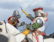Fight of horse knights in an armour and helmets Fight of horse knights in an armour and helmets