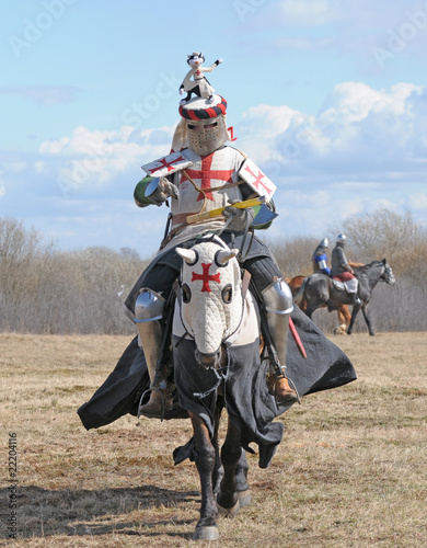 Photo: The knight on horseback and holding in a hand an axe The knight on horseback and holding in a hand an axe