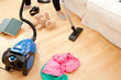 Woman vacuuming the living-room Woman vacuuming the living-room