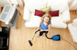 High angle of a happy woman vacuuming High angle of a happy woman vacuuming