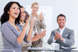 Cheerful business people applauding in a meeting
