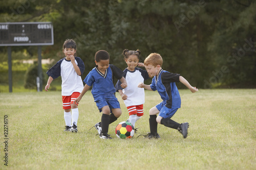 Photo: Children playing soccer outdoors Children playing soccer outdoors