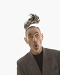 Studio shot of man with toupee floating above head