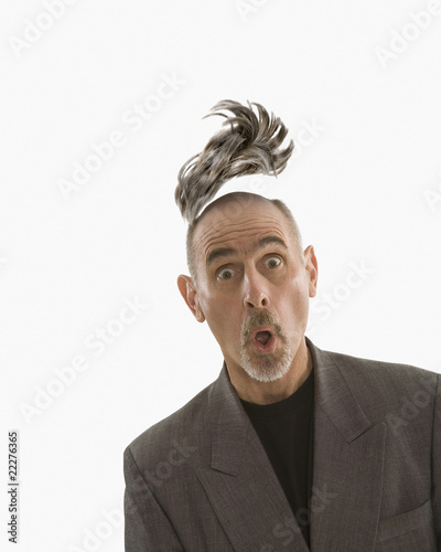 Photo: Studio shot of man with toupee floating above head Studio shot of man with toupee floating above head