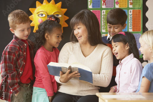 Photo: Asian female teacher reading to students Asian female teacher reading to students