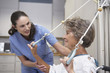 Senior female patient performing physical therapy with nurse