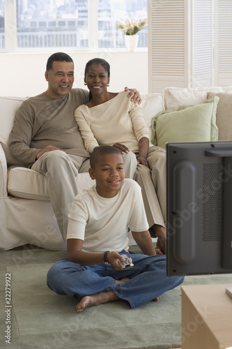 Photo: African family watching television in livingroom African family watching television in livingroom