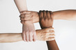 Multi-ethnic women holding wrists
