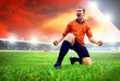 Happiness football player after goal on the field of stadium wit