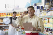 Hispanic father and son working in family owned bodega