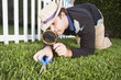 Man cutting grass with scissors