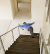 Hispanic man on floor at bottom of stairs