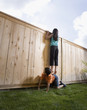 Middle Eastern girl on boy's back looking over fence