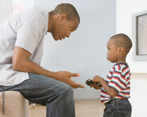 Photo: African American father talking to son African American father talking to son