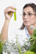 Maltese female scientist examining vial of liquid