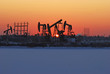 Oil rigs silhouette over orange sky-10