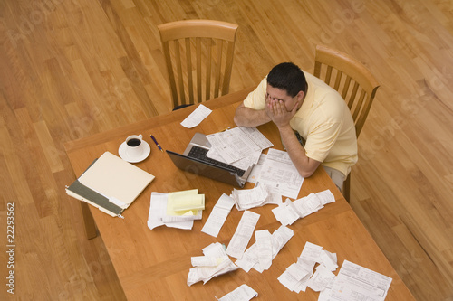 Photo: Hispanic man paying bills Hispanic man paying bills