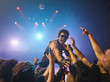 Male rock star on stage interacting with audience