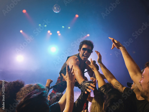 Photo: Male rock star on stage interacting with audience Male rock star on stage interacting with audience