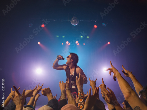Photo: Male rock star performing in front of audience Male rock star performing in front of audience