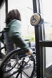 African man in wheelchair using automatic door
