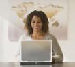 African businesswoman looking at laptop