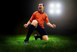 Happiness football player after goal on the field of stadium wit Happiness football player after goal on the field of stadium wit