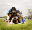 Multi-ethnic male soccer players in pile up
