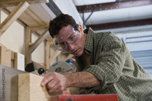 Photo: Hispanic man working in wood shop Hispanic man working in wood shop