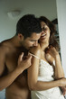 Hispanic man kissing girlfriend's shoulder