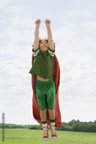 Photo: Mixed Race boy flying with towel as cape Mixed Race boy flying with towel as cape