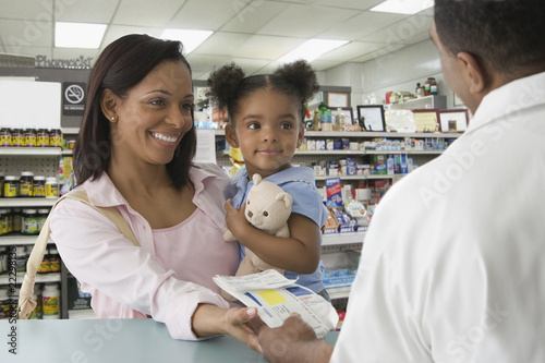 Photo: African mother and daughter getting prescription at pharmacy African mother and daughter getting prescription at pharmacy