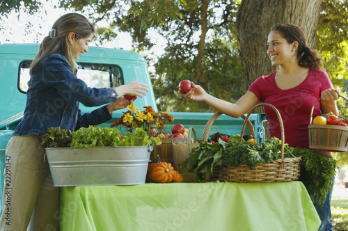Photo: Hispanic women at organic farm stand Hispanic women at organic farm stand