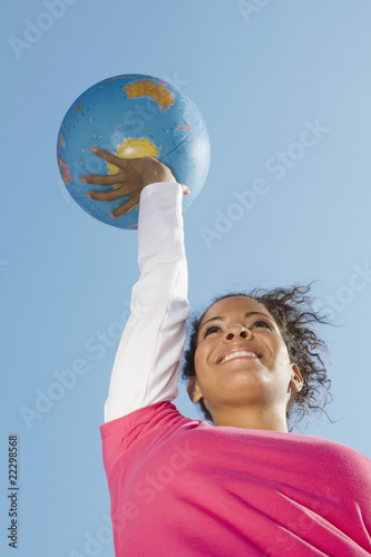 Photo: Hispanic woman holding globe ball Hispanic woman holding globe ball
