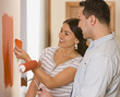 Hispanic couple looking at paint swatches