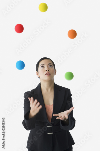 Photo: Asian businesswoman juggling Asian businesswoman juggling