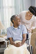 Middle Eastern woman smiling at man in wheelchair
